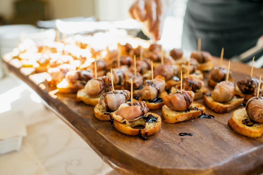 Photo by Lucas T Photography Wooden board filled with small appetizers on bread.
